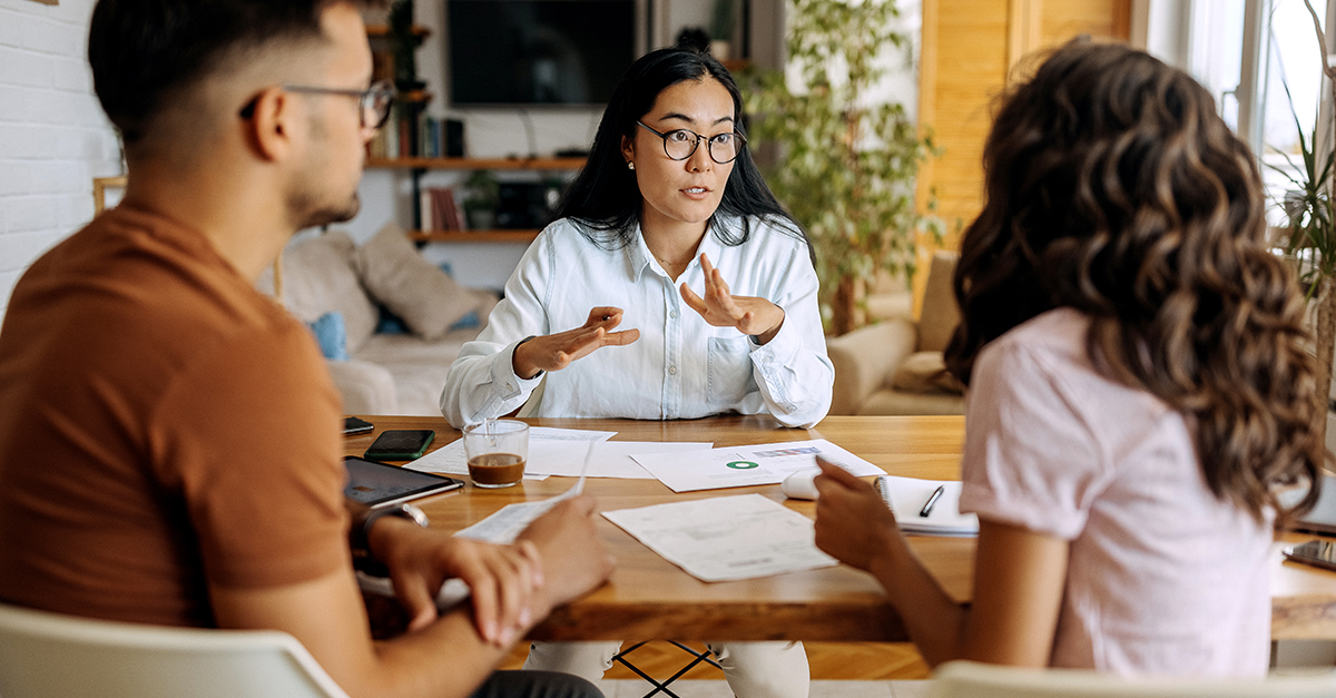 A couple discuss insurance policies with an agent