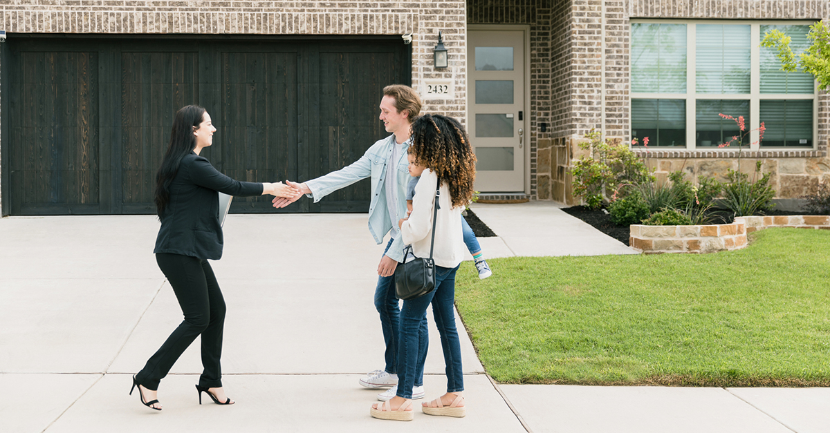 Agent shakes clients hand outside of home